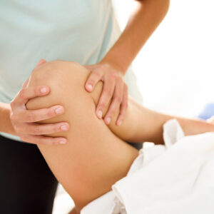 Medical massage at the leg in a physiotherapy center.